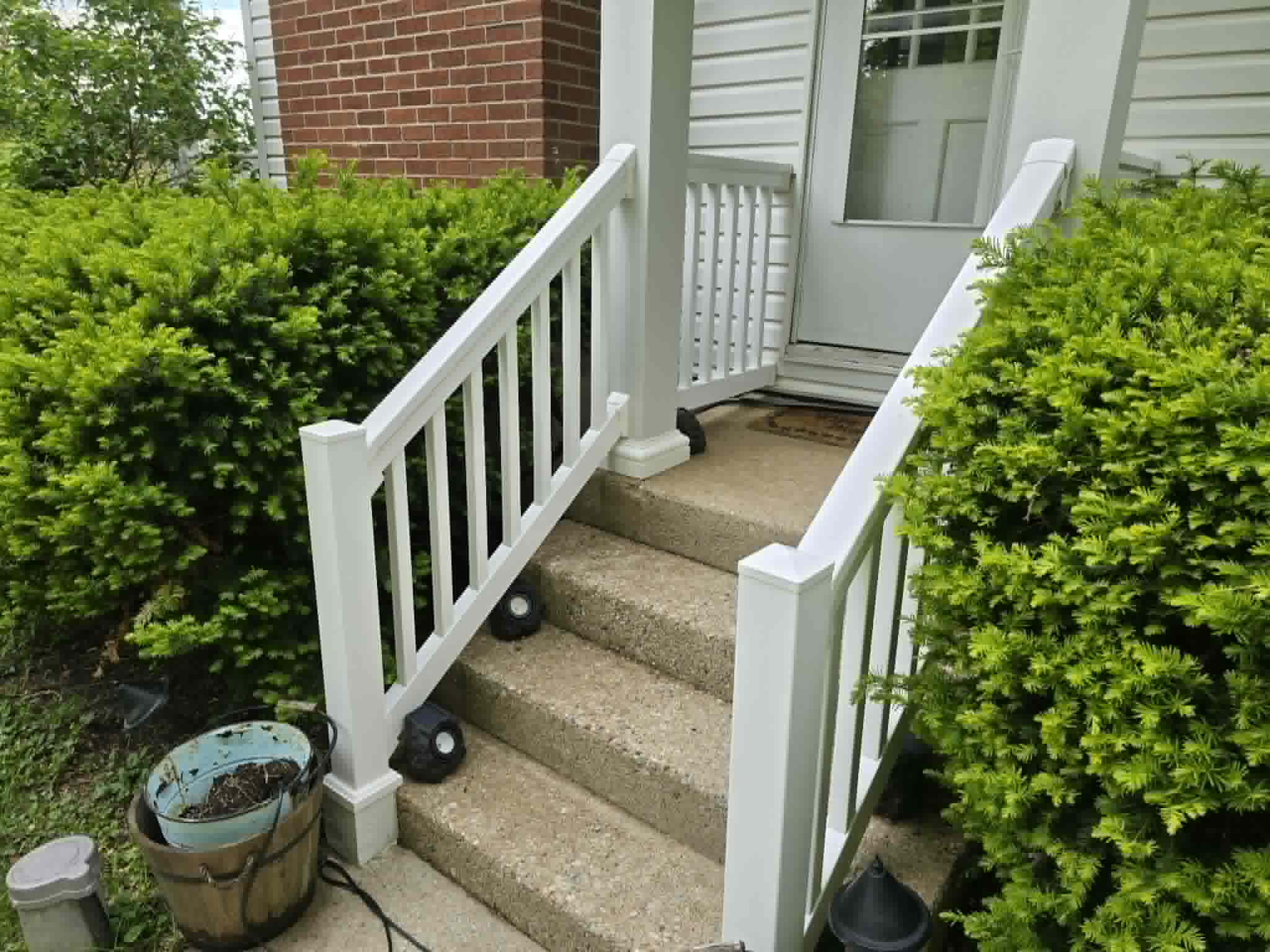 Porch stairs and white railing after house washing in Dayton Ohio